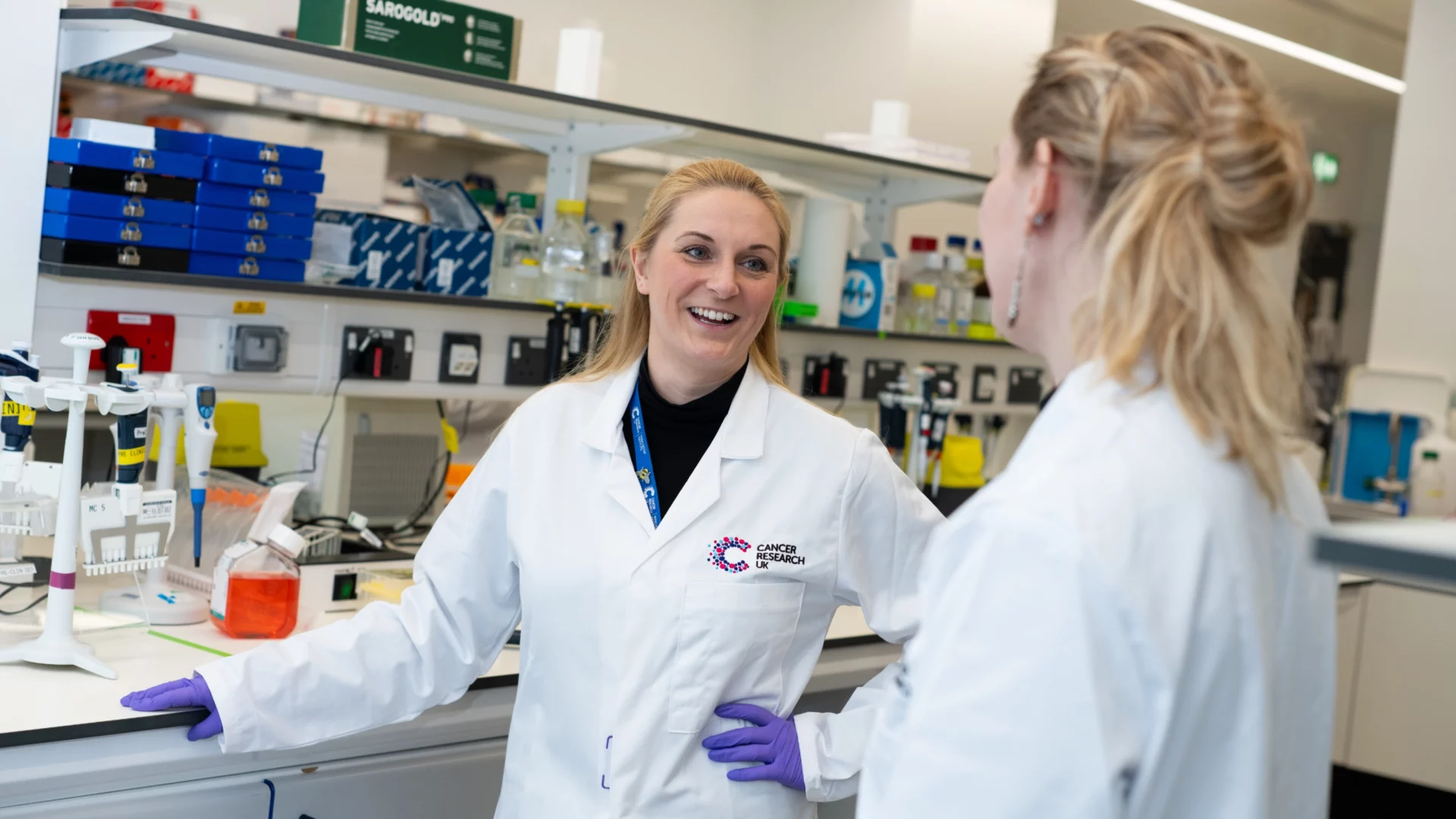 Iimage showing laboratory work with two scientists sharing ideas