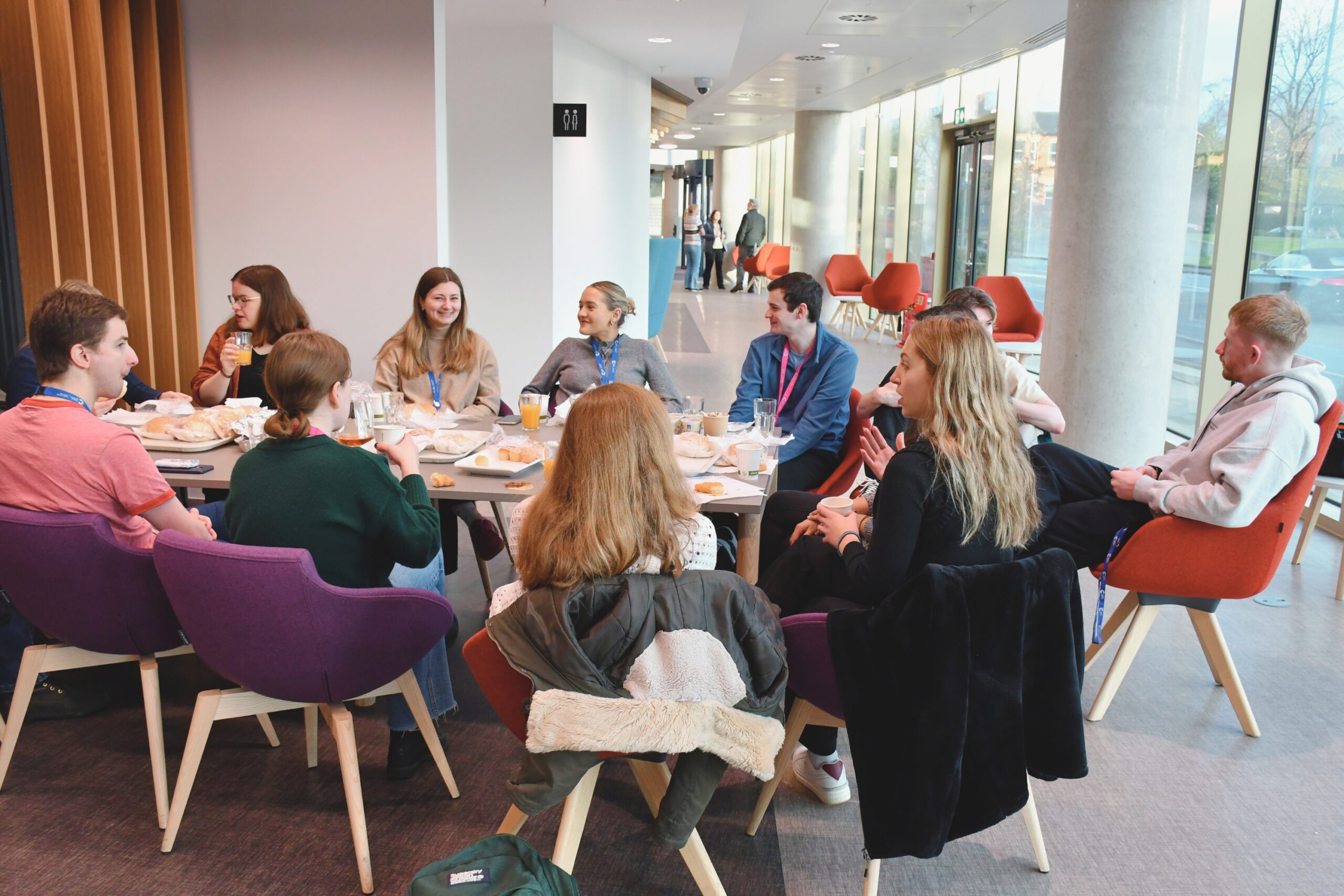 A group of PhD students socialising at table