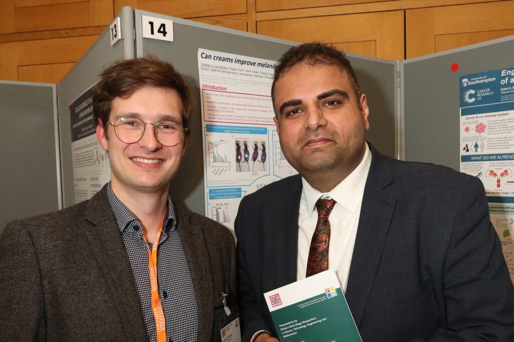 Institute Scientist standing in front of his poster with Navendu Mishra MP for Stockport